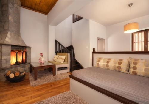 a bedroom with a bed and a fireplace at Κonitsa Gefyri hotel in Konitsa