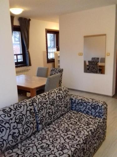 een woonkamer met een bank en een tafel bij City View Apartment in Fojnica