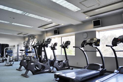 a gym with a bunch of tread machines in a room at International Garden Hotel Narita in Narita