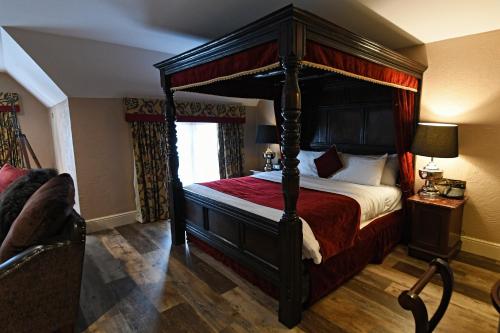 a bedroom with a canopy bed and a window at Best Western Premier Doncaster Mount Pleasant Hotel in Doncaster