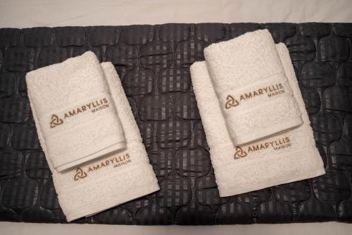 two white towels sitting on top of a table at Amaryllis Maison Hili in Alexandroupoli