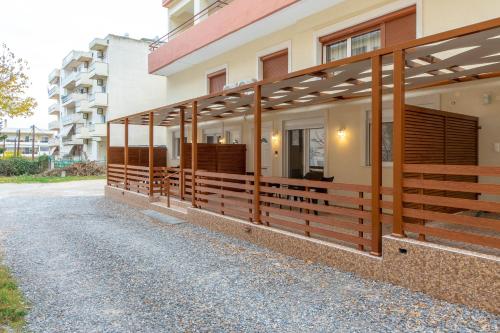 a building with wooden fence on the side of it at Amaryllis Maison Hili in Alexandroupoli