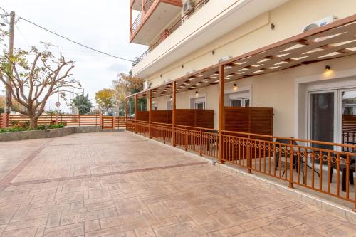a balcony of a building with a wooden fence at Amaryllis Maison Hili in Alexandroupoli