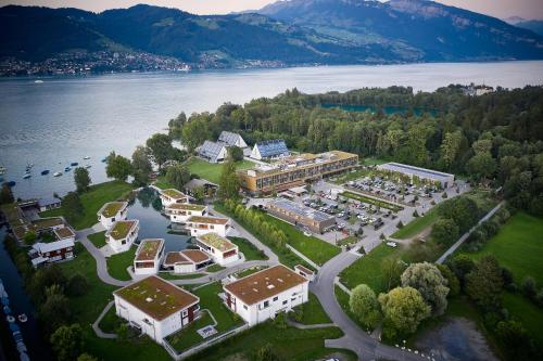 a large body of water with houses and trees at Deltapark Vitalresort**** in Thun