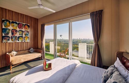a bedroom with a bed and a large window at LetsBunk Poshtel & Suites in New Delhi