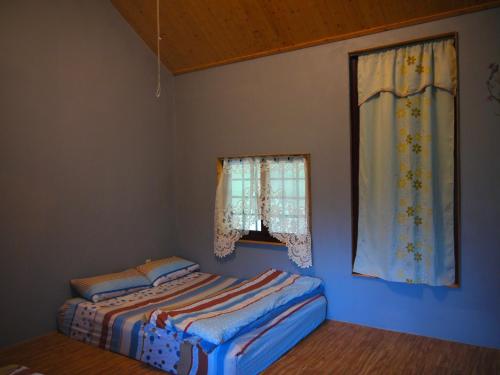 a bedroom with two beds and a window at Taroko Railway Authentic B&B in Xiulin