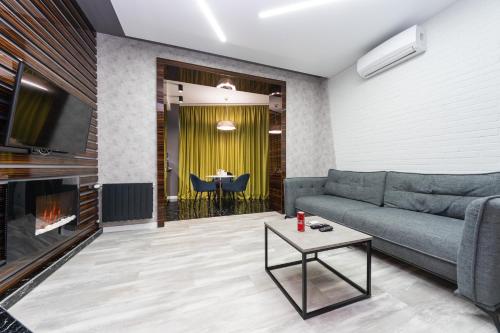 a living room with a couch and a fireplace at Luxury Apartments Arena Guliver in Kyiv