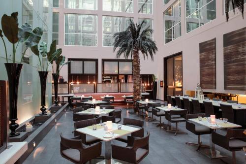 a large room filled with tables and chairs at Centro Barsha - by Rotana in Dubai