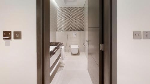 a bathroom with a toilet and a mirror at Suha Mina Rashid Hotel Apartments in Dubai