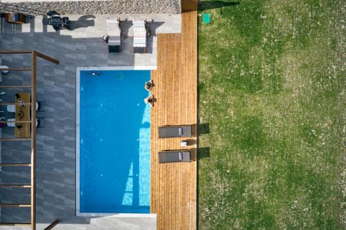 an overhead view of a yard with a blue door at Anar Villas Rhodes in Koskinou