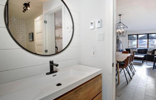a bathroom with a sink and a mirror on the wall at Chalets Alpins - 12 Chemin Alpin in Stoneham
