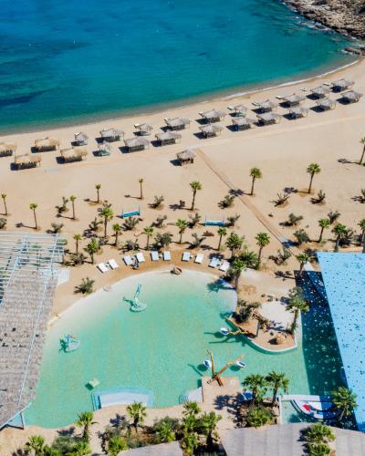 an aerial view of a beach with chairs and umbrellas at Calilo in Manganari