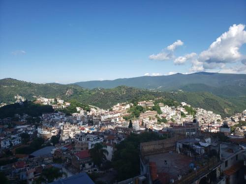 an aerial view of a city with mountains in the background at Casa Vista Taxco in Taxco de Alarcón