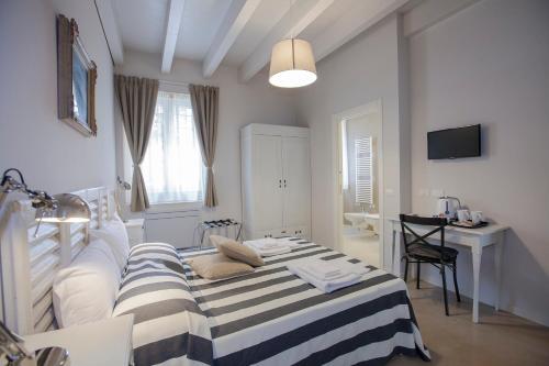 a bedroom with a bed and a desk in it at Balbianino in Lenno