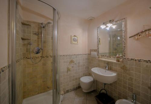 a bathroom with a shower and a sink and a toilet at NICE APARTMENT in Porto Santo Stefano