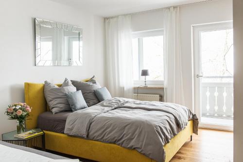 a bedroom with a large bed with a yellow headboard at Zauberhaft im Naturpark Altmühltal in Greding