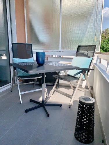 two chairs and a table on a balcony at Bijou Lido Golf Ascona in Ascona