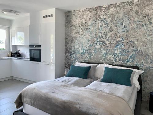 a bedroom with a large bed and a wall mural at Bijou Lido Golf Ascona in Ascona