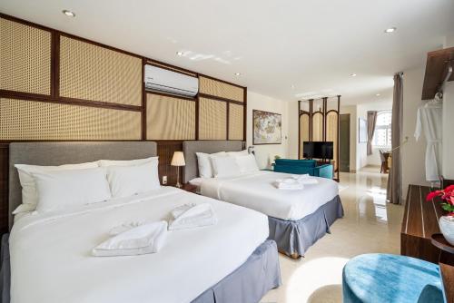 a hotel room with two beds and a living room at Aquatel Vung Tau in Vung Tau