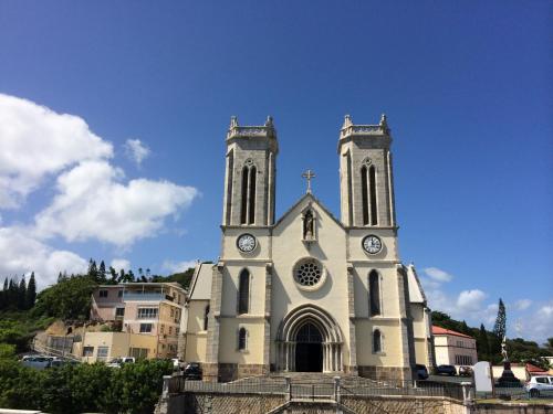 a church with two towers with clocks on it at Hotel Le Paris in Noumea