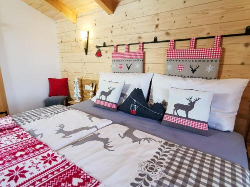 a bedroom with a bed with red and white pillows at Chalex in Aigen im Mühlkreis