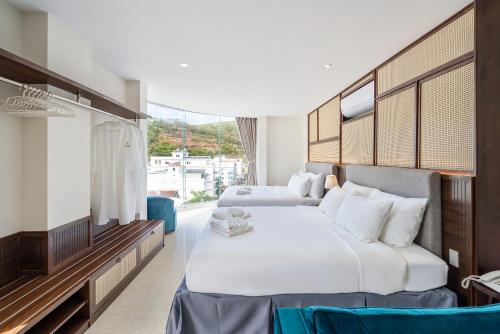 a hotel room with two beds and a window at Aquatel Vung Tau in Vung Tau
