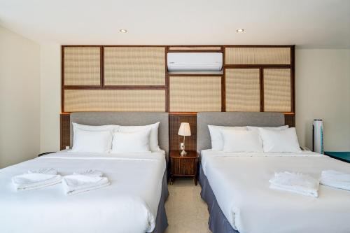 two beds sitting next to each other in a bedroom at Aquatel Vung Tau in Vung Tau