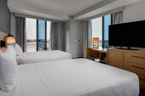 a hotel room with two beds and a television at Hyatt Place Boston/Seaport District in Boston