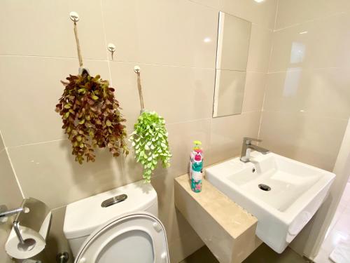 a bathroom with a toilet and a sink at 3BR Near Desa Park City MONT KIARA in Kuala Lumpur