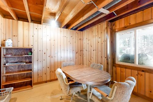 a wooden dining room with a wooden table and chairs at High Lake Hideaway in Boulder Junction