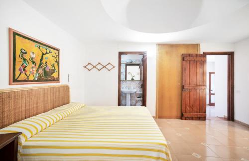 a bedroom with a bed with a striped mattress at Residence del Sole in Lampedusa