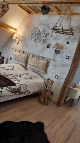 a bedroom with a bed with a mural on the wall at Le nid'Ange in Torcy