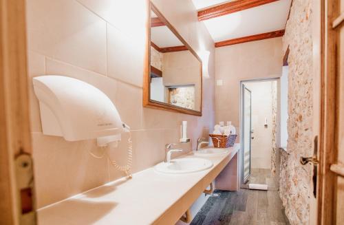a bathroom with two sinks and a mirror at Hotel-Restaurant Kriva Ćuprija in Mostar