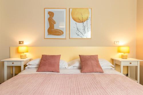 a bedroom with a bed with two tables and two lamps at Agriturismo il Bio Nonno in Cento