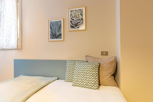 a bedroom with a bed with two pictures on the wall at Agriturismo il Bio Nonno in Cento