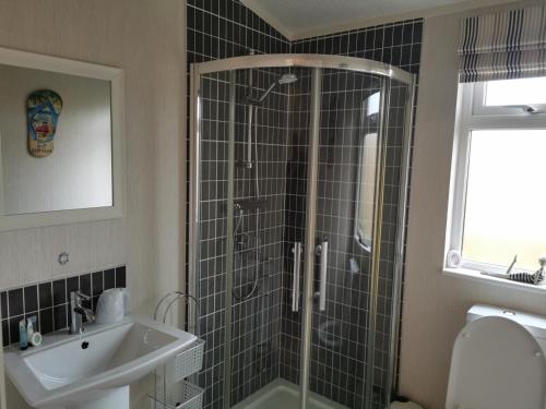 a bathroom with a shower and a sink at Captivatingly Stunning 2-Bed Cabin in Bridlington in Bridlington