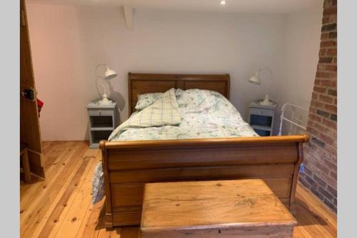 a bedroom with a bed with two tables and two lamps at Riversmeet Cottage where the two Rivers meet ? in Tiverton