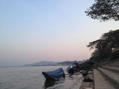 a group of boats parked on the side of the water at Pak Ping Rim Khong in Chiang Saen