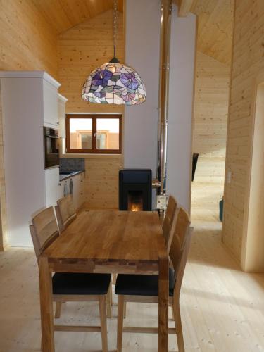 a dining room with a wooden table and chairs at Chalet Stressless in Presseggen