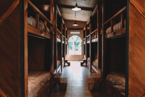 a hallway with wooden shelves in a room with a window at Elena Hostel in Tandil