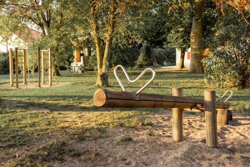 a wooden bench with a heart on it in a park at Agriturismo il Bio Nonno in Cento