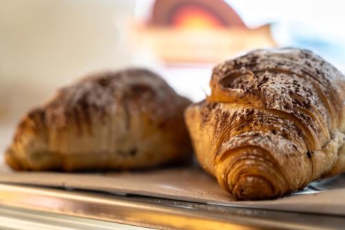 two loaves of bread sitting on a tray at Hotel Ginepro in Qualiano