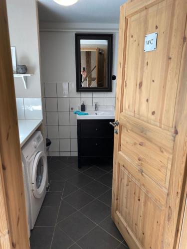 a bathroom with a sink and a toilet and a door at Ferienhaus Anno 1599 in Wernigerode