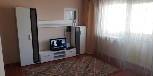 sala de estar con TV y espejo en Apartament Pitesti, en Piteşti
