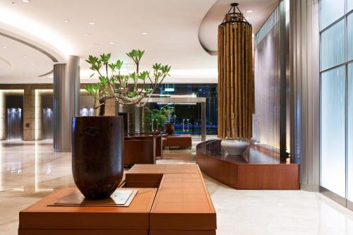 a lobby with a vase sitting on a table at Ambassador Hotel Hsinchu in Hsinchu City
