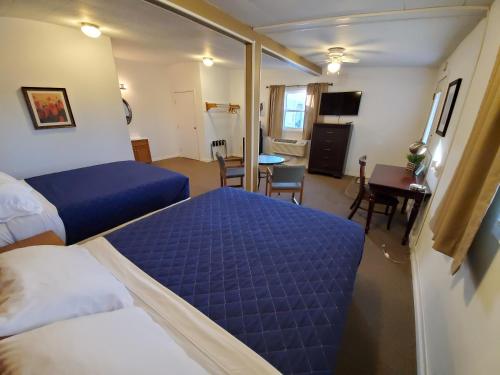 a hotel room with two beds and a dining room at TKTK in Rapid City