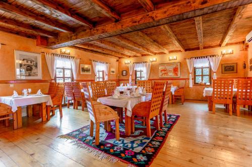 
a dining room table and chairs in a room at Hotel-Restaurant Kriva Ćuprija in Mostar
