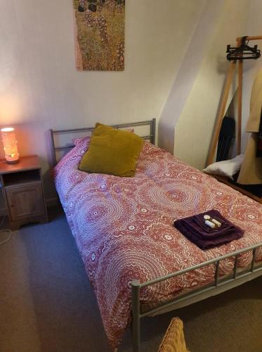 a bedroom with a bed with a blanket on it at Victorian Townhouse in Banbury