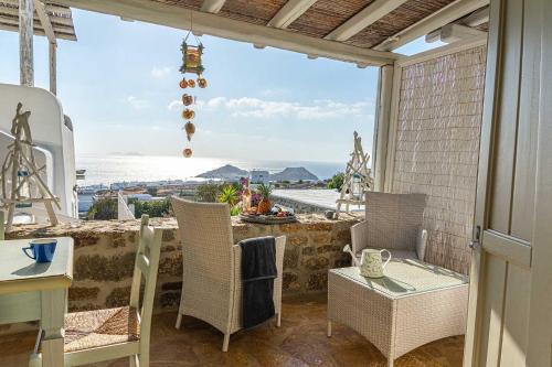 a balcony with chairs and a view of the ocean at Villa Azallea by Mykonian Kazarte in Kalafatis