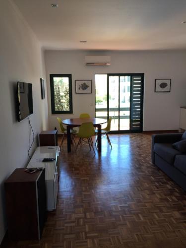 a living room with a couch and a table at Tossan House in Vilamoura Downtown in Quarteira